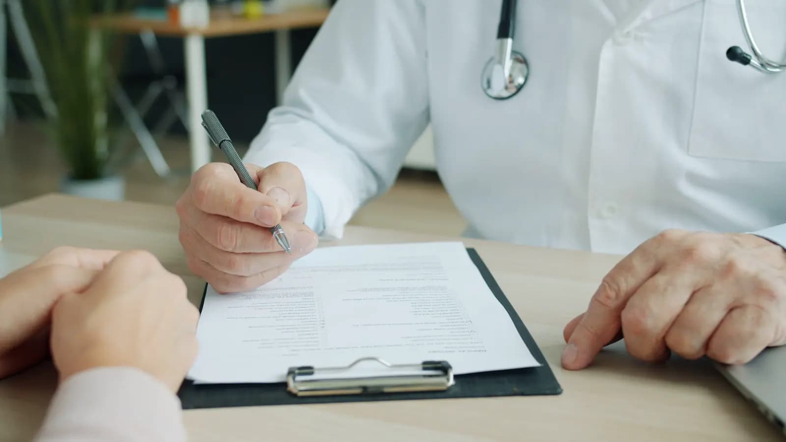 A clinician and patient reviewing paperwork together
