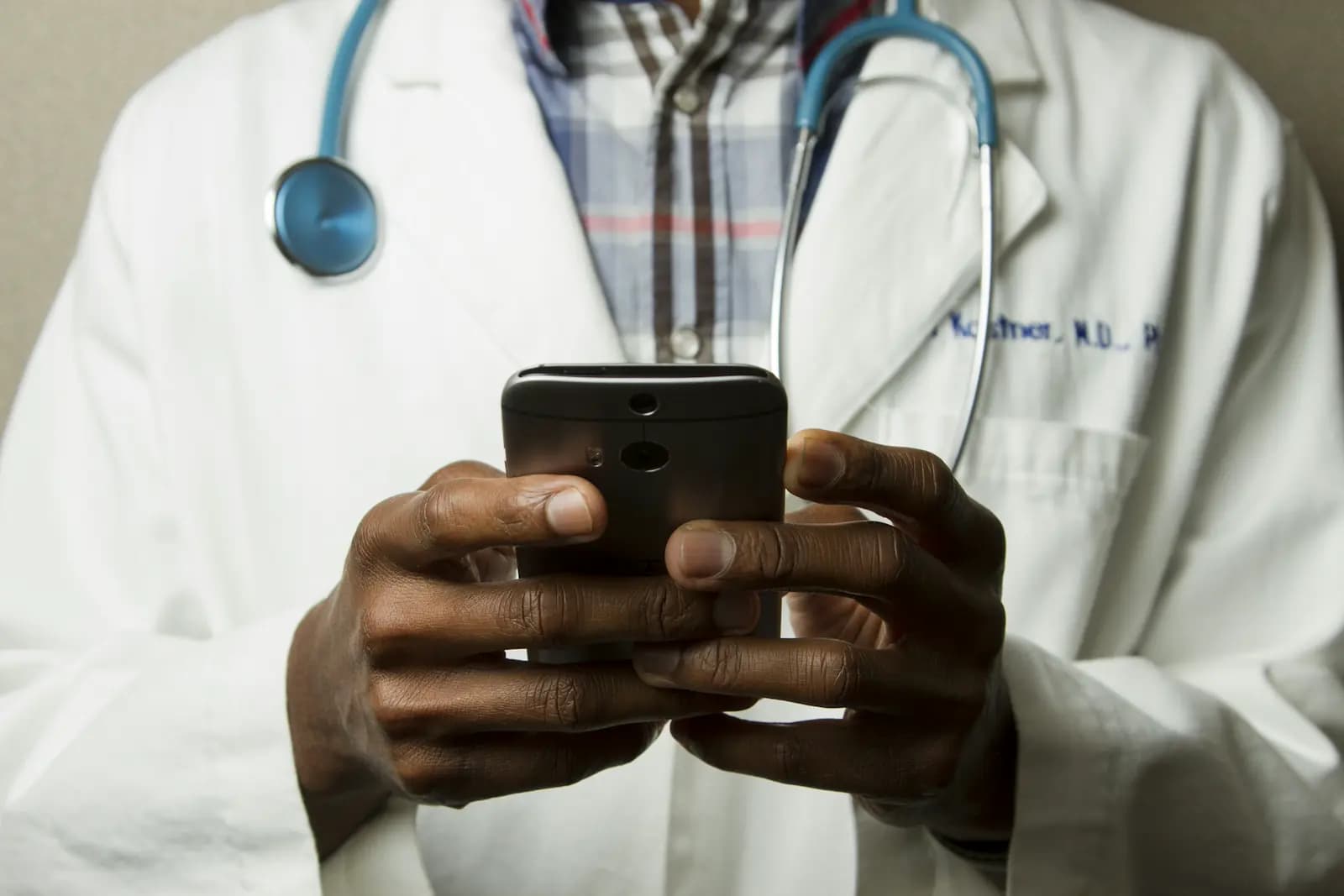 A physician reviewing a patient's paperwork across a desk